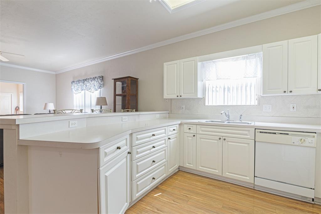 4748 Northwest 77 Road Gainesville, FL 32653 - Photo 7 of 21 a kitchen with granite countertop white cabinets white appliances and sink