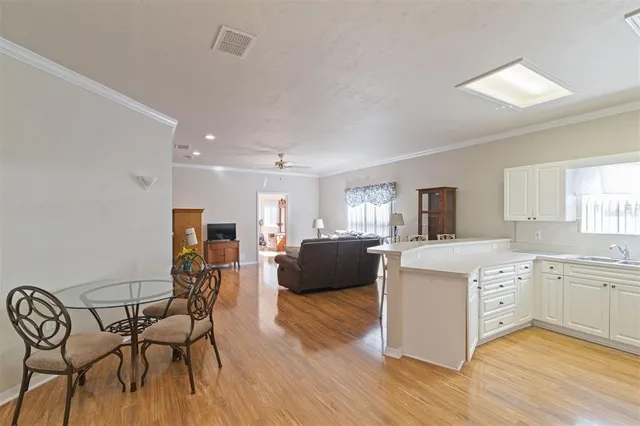 a living room with furniture and kitchen view