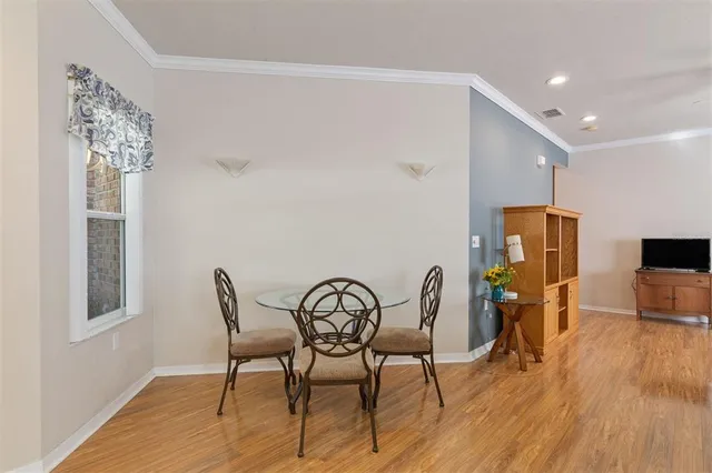 a view of a dining room with furniture and wooden floor