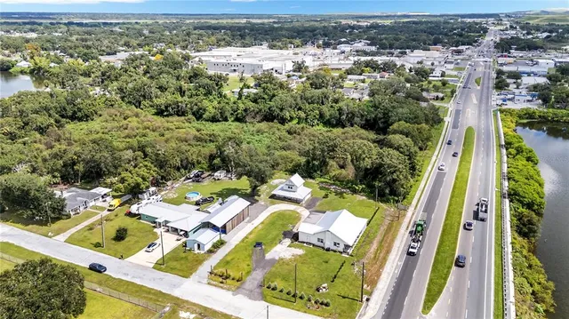 an aerial view of a house with swimming pool and lake view