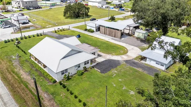 an aerial view of a house with a yard