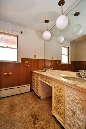 a kitchen with stainless steel appliances a stove a sink dishwasher and cabinets with wooden floor