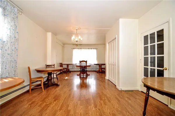 a view of a dining room with furniture window and wooden floor