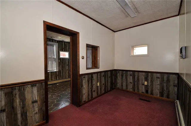 a view of a hallway with a livingroom and furniture