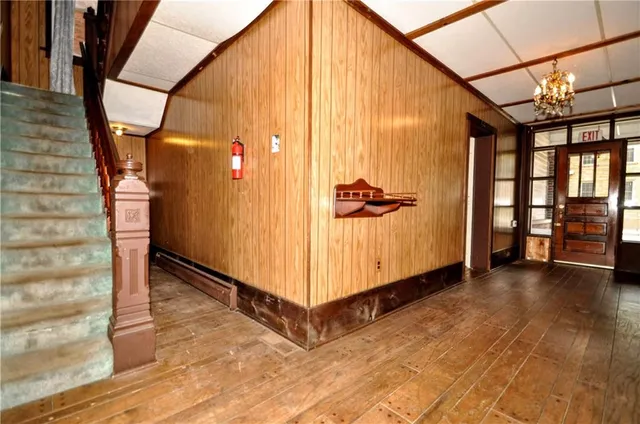 a view of a hallway with wooden floor and entryway