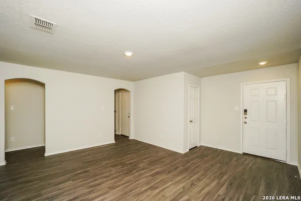 a view of room with wooden floor