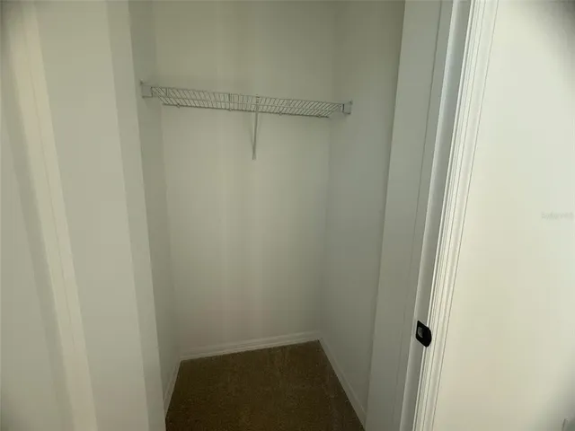 a bathroom with a sink a toilet a mirror a vanity and bathtub