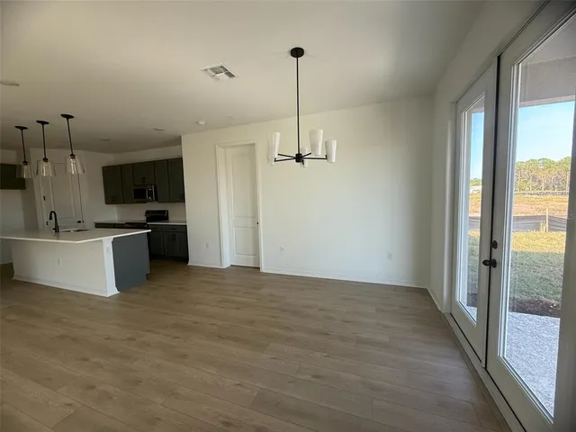 a view of a kitchen with a sink wooden cabinet and a living room