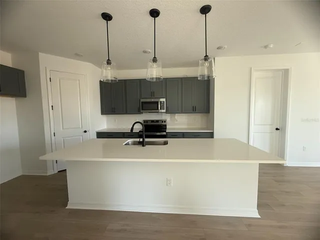 a view of a kitchen with stainless steel appliances
