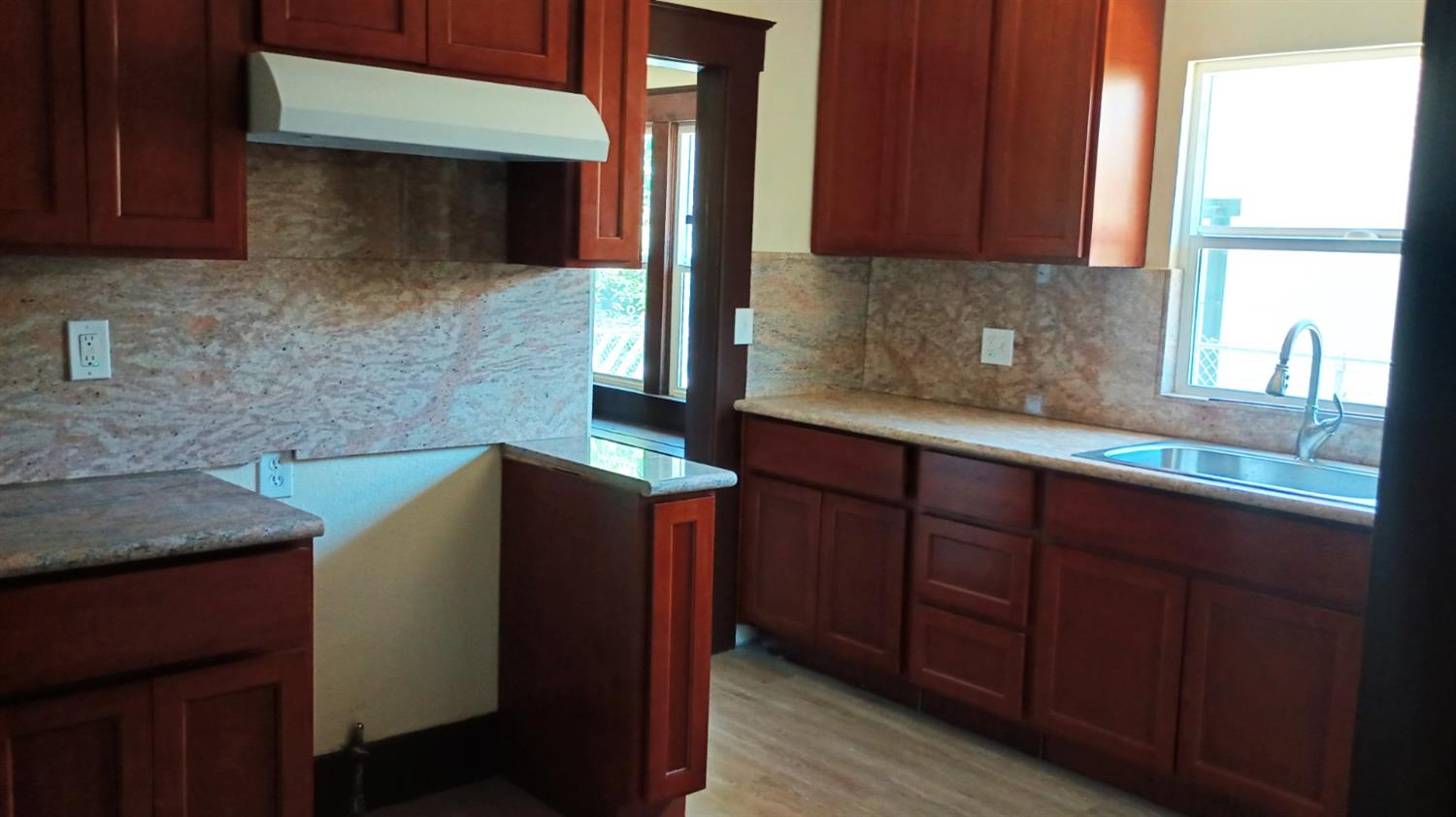 1327 North Ferger Avenue Fresno, CA 93728 - Photo 8 of 22 a kitchen with stainless steel appliances granite countertop wooden cabinets a sink and dishwasher