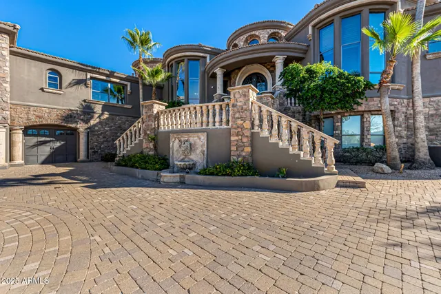 a front view of a building with a garden