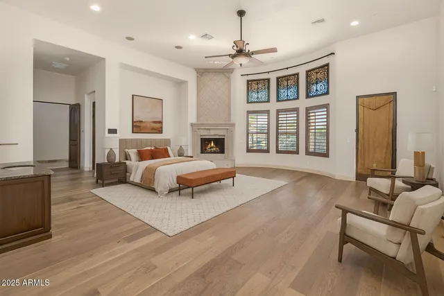 a bathroom with a granite countertop sink a toilet and a mirror
