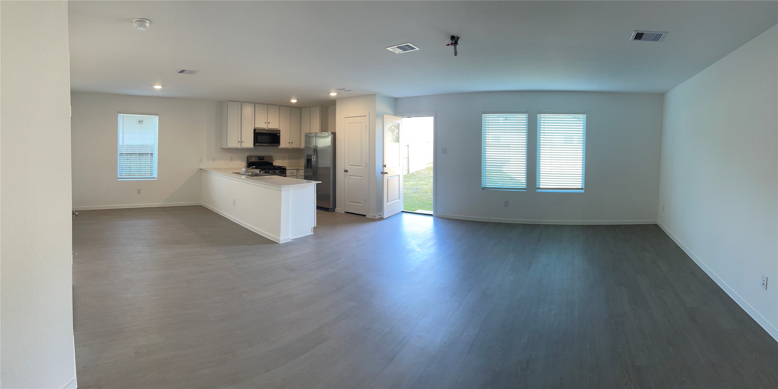 1391 Diamond Carnation Drive Conroe, TX 77301 - Photo 6 of 26 a living room with hard wood floors and white walls