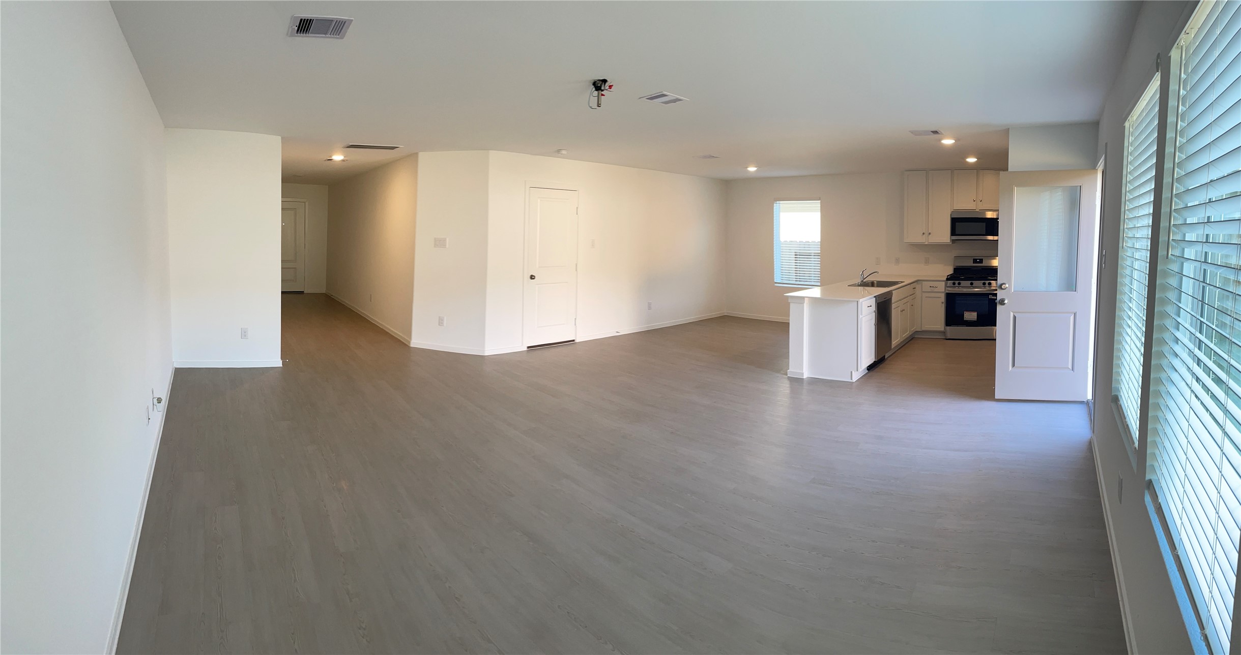 1391 Diamond Carnation Drive Conroe, TX 77301 - Photo 7 of 26 a view of a kitchen with a sink and a refrigerator