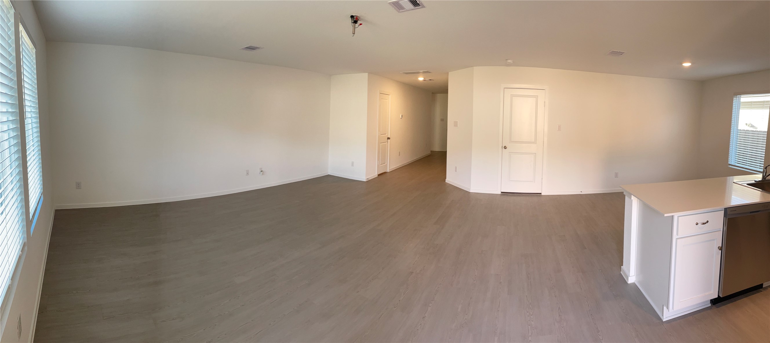 1391 Diamond Carnation Drive Conroe, TX 77301 - Photo 8 of 26 an empty room with wooden floor and windows