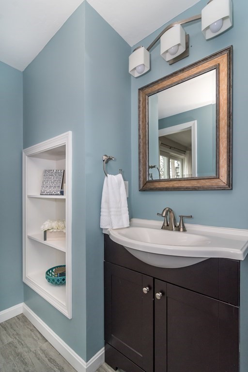15 Sheffield Road Natick, MA 01760 - Photo 11 of 30 a bathroom with a sink and a mirror with toilet