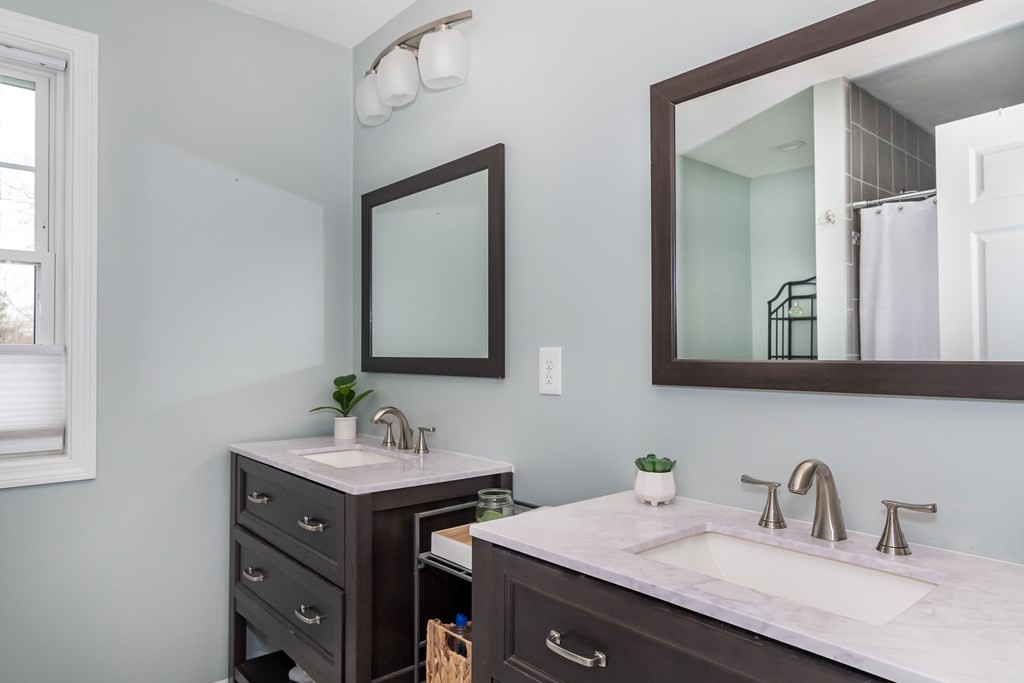 15 Sheffield Road Natick, MA 01760 - Photo 19 of 30 a bathroom with a double vanity sink and mirror