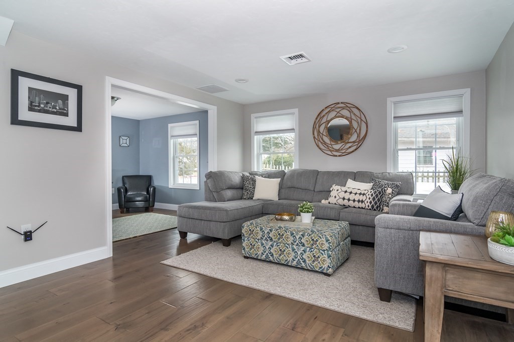 15 Sheffield Road Natick, MA 01760 - Photo 8 of 30 a living room with couches and a large window with wooden floor