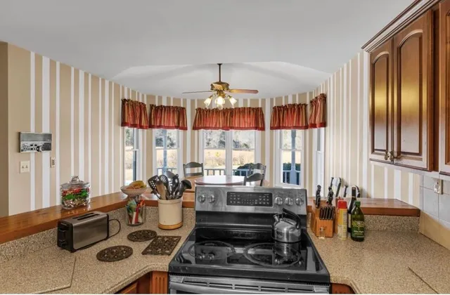a kitchen with stainless steel appliances wooden cabinets a sink and a window