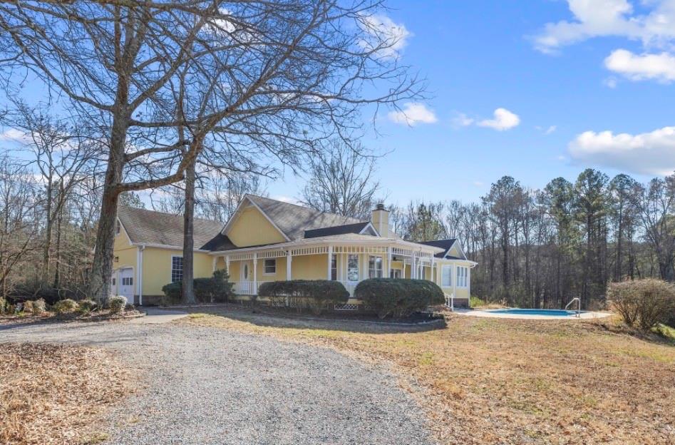 1776 Wax Road Silver Creek, GA 30173 - Photo 2 of 48 a front view of a house with a yard and trees