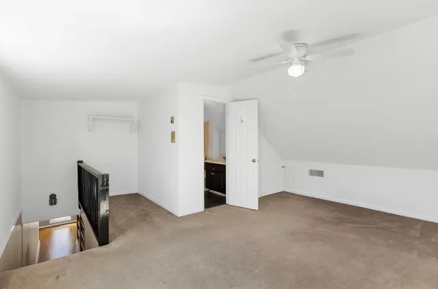 a bathroom with a bathtub sink vanity and mirror