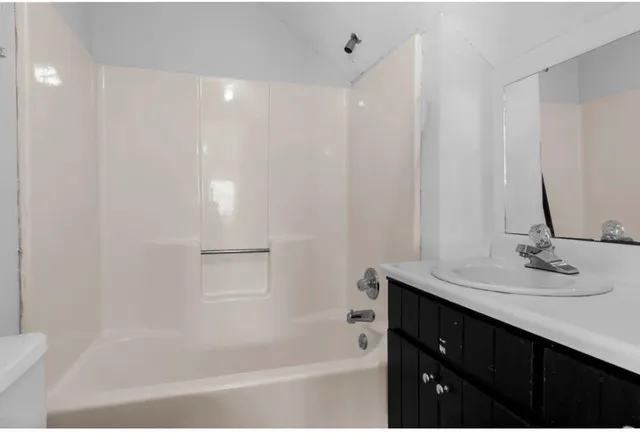 a view of a hallway with wooden floor and stairs