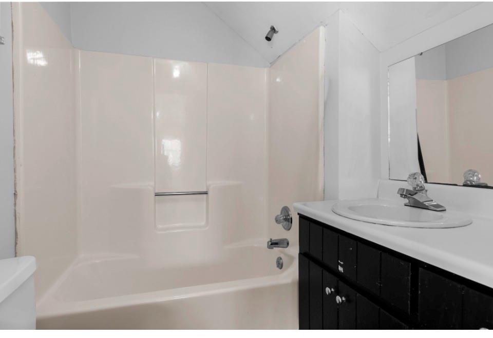 1776 Wax Road Silver Creek, GA 30173 - Photo 28 of 48 a bathroom with a bathtub sink vanity and mirror
