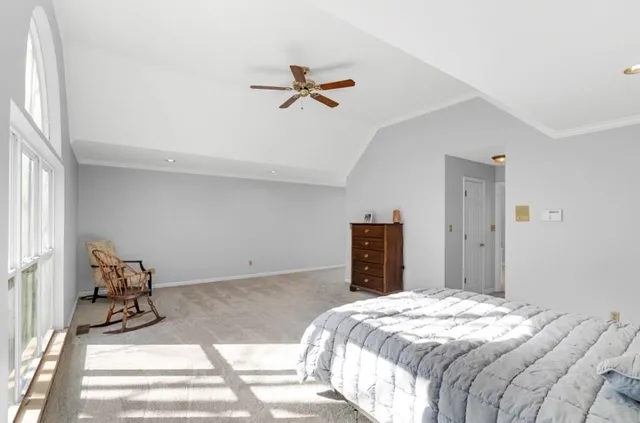 a bedroom with a bed and glass door