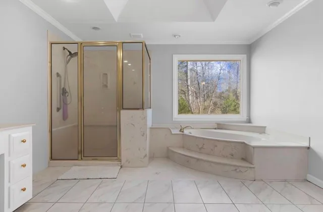 a spacious bathroom with double sink large mirror and a window