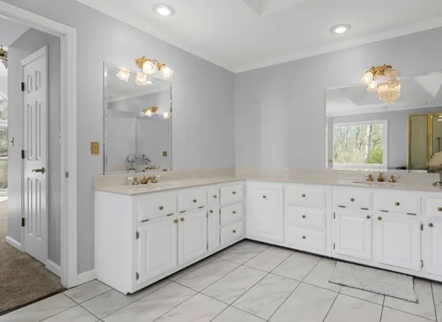 a view of kitchen with a sink cabinets and window