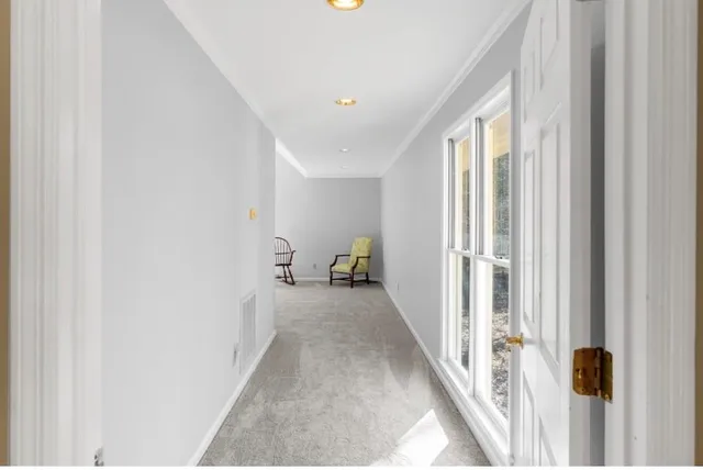 a hallway with wooden floor and closet