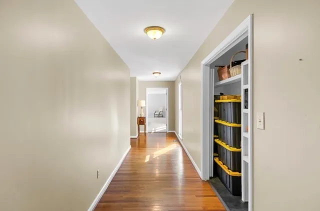 a view of a hallway with wooden floor