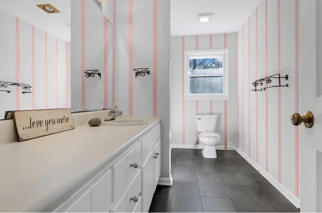 a bathroom with a toilet sink and shower