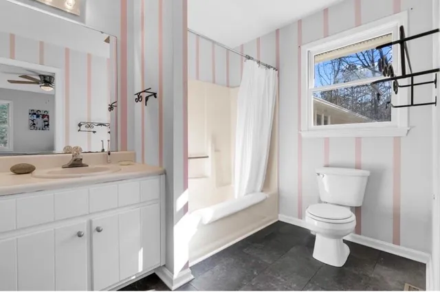 a bedroom with furniture and a large window