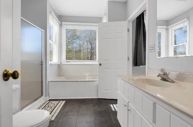 a view of a room with gym equipment and wooden floor