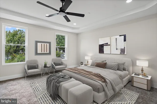 a bedroom with a bed a couch and a window