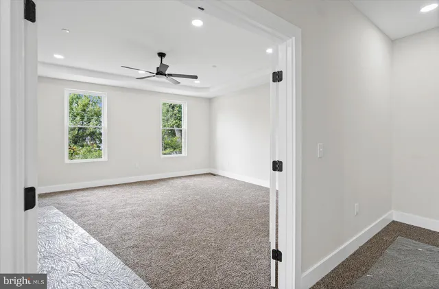an empty room with windows and closet