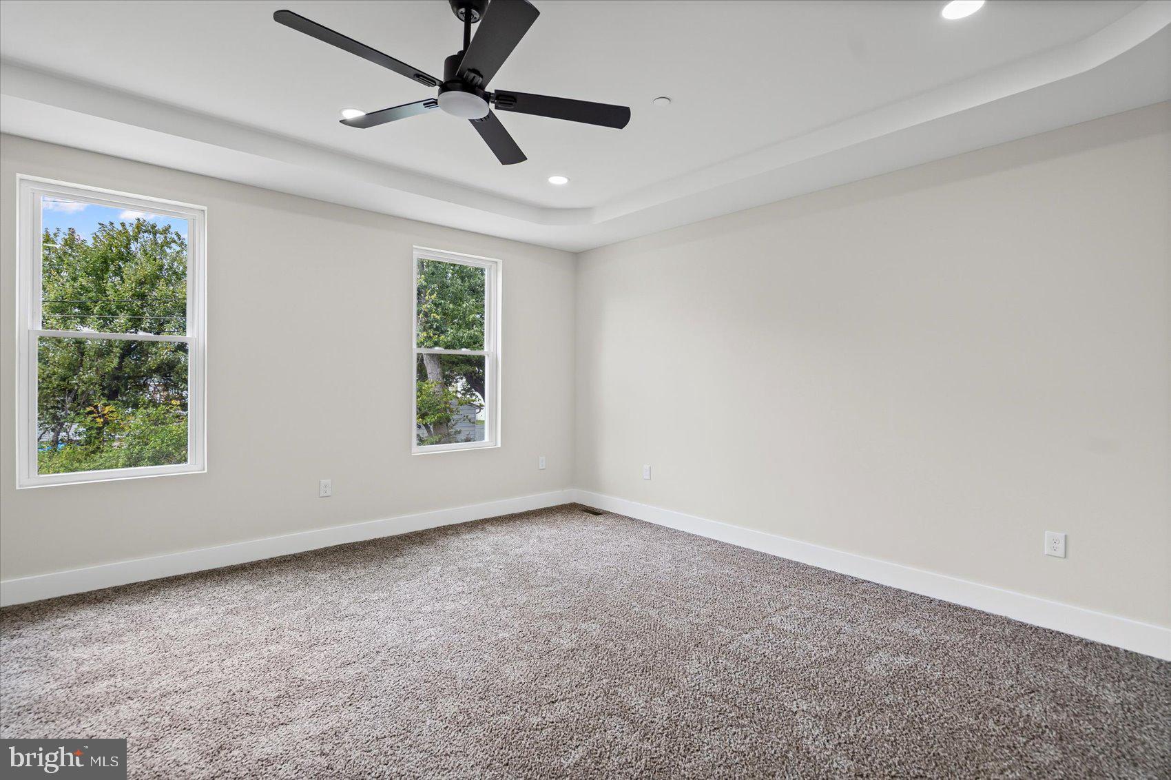 9534 Bauer Avenue Baltimore, MD 21236 - Photo 19 of 53 an empty room with windows and ceiling fan