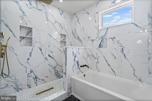 a bathroom with a bathtub and a shower