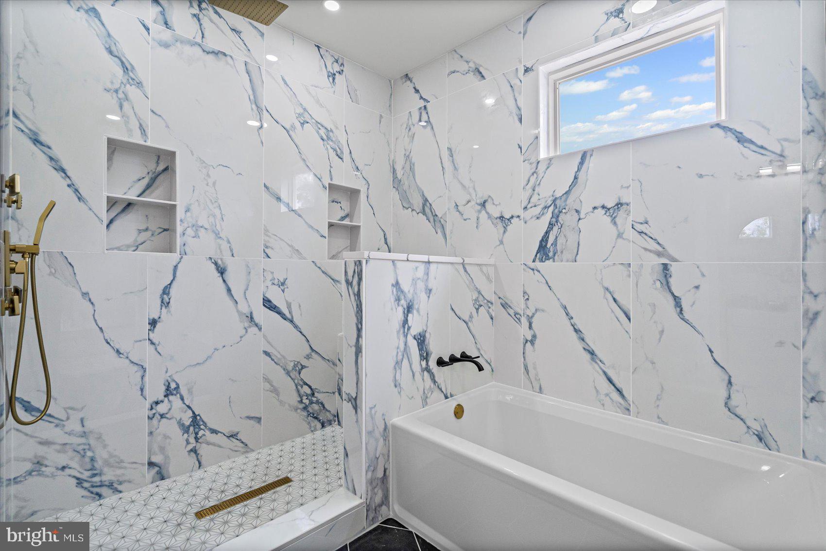 9534 Bauer Avenue Baltimore, MD 21236 - Photo 25 of 53 a bathroom with a bathtub and a shower