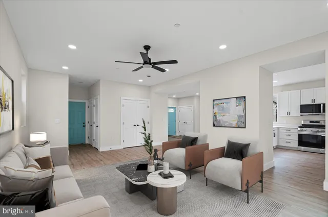 a living room with furniture and a wooden floor