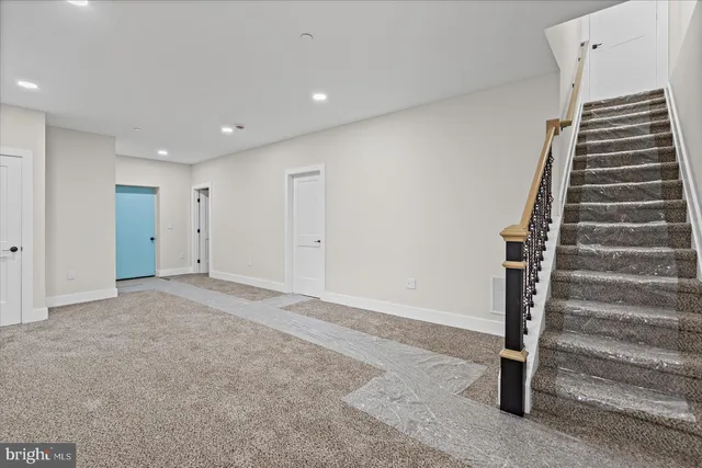 a view of an empty room with stairs