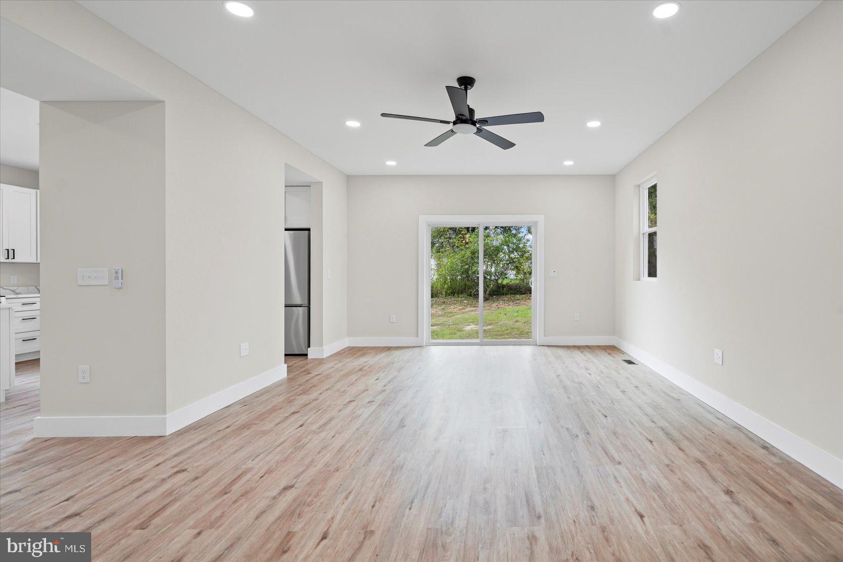 9534 Bauer Avenue Baltimore, MD 21236 - Photo 6 of 53 a view of empty room with wooden floor and fan
