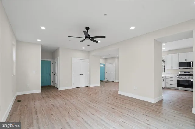 a view of a kitchen with a sink and a refrigerator
