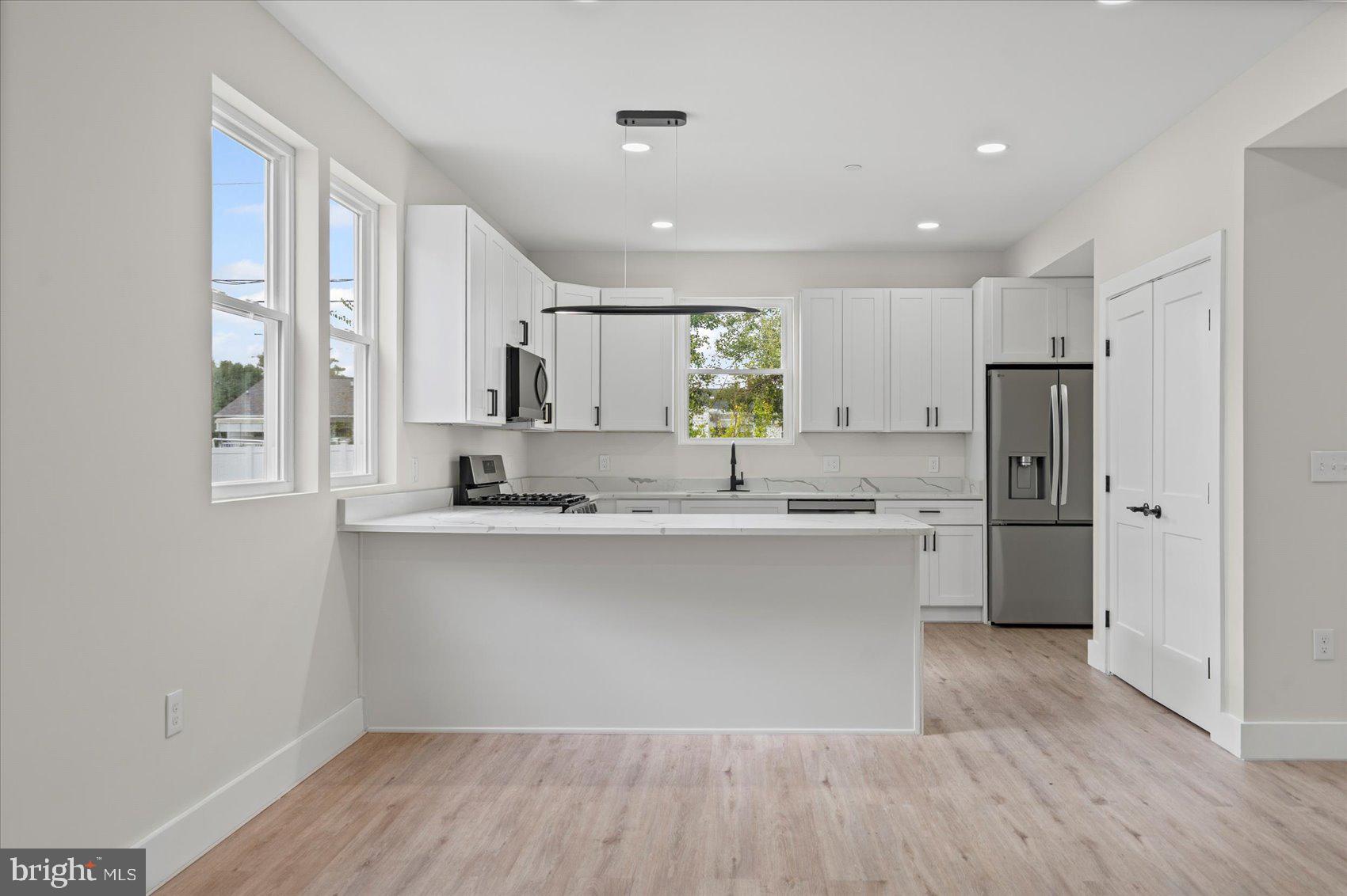 9534 Bauer Avenue Baltimore, MD 21236 - Photo 9 of 53 a kitchen with a refrigerator sink and cabinets