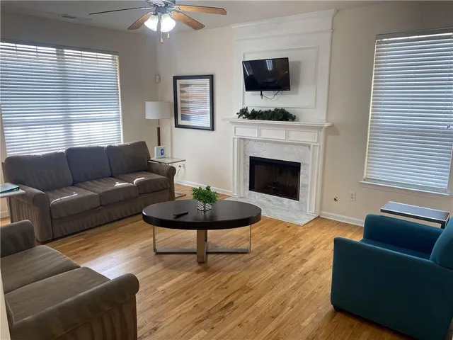 a living room with furniture a fireplace and a flat screen tv