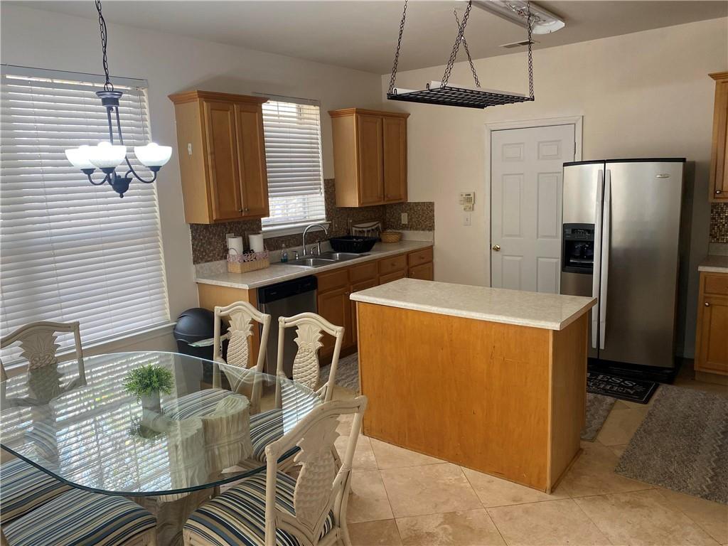 541 Cascade Hills Court Southwest Atlanta, GA 30331 - Photo 12 of 38 a kitchen with stainless steel appliances granite countertop a sink dishwasher a refrigerator and a dining table with wooden floor
