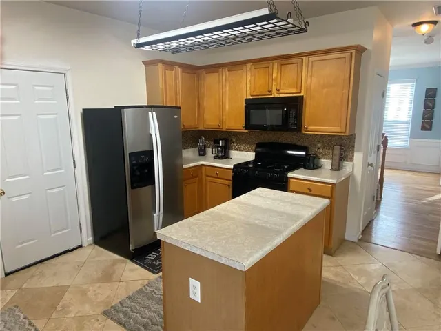a kitchen with a refrigerator a stove top oven a sink and dishwasher