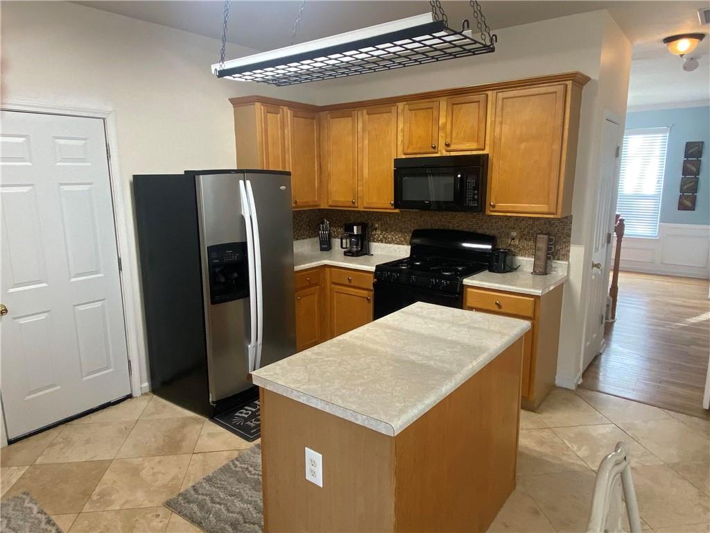 541 Cascade Hills Court Southwest Atlanta, GA 30331 - Photo 18 of 38 a kitchen with a refrigerator a stove top oven a sink and dishwasher