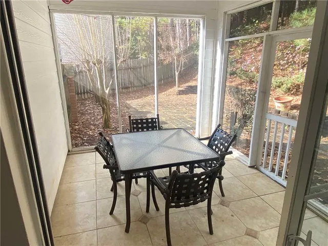 a view of a room with a table and chairs
